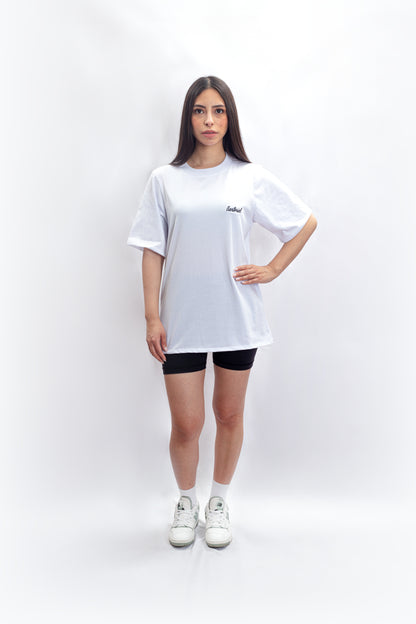 An effortlessly chic outfit featuring fashion essentials: a timeless white basic t-shirt paired with edgy black biker shorts and stylish sneakers, showcasing the versatility of wardrobe basics in contemporary fashion.