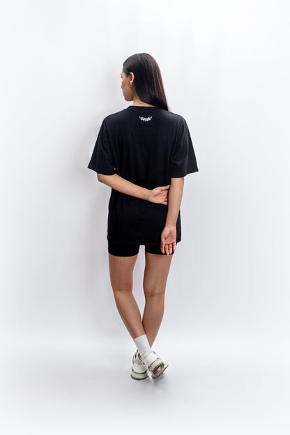 An effortlessly chic outfit featuring fashion essentials: a timeless black basic t-shirt paired with edgy black biker shorts and stylish sneakers, showcasing the versatility of wardrobe basics in contemporary fashion