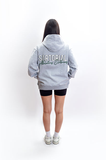 An athletic individual donning a heavyweight grey hoodie adorned with the Sartorial Athletics logo in the front, showcasing its versatile blend of sartorial quality and athletic aesthetics. Elevate your casual, vintage, or aesthetic outfits effortlessly with this premium-quality hoodie from Sartorial Athletics