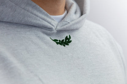 A close-up shot of a heavyweight grey hoodie featuring intricate flock details, highlighting the quality of the fabric and technique used. These fine details elevate both your outfit and aesthetics, showcasing the craftsmanship of this premium garment